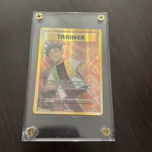 Pokémon card encased Trainer BROCK’S Grit